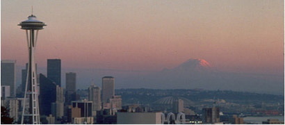 The Seattle Space Needle and Mt Rainier keep watch over the Puget Sound Region